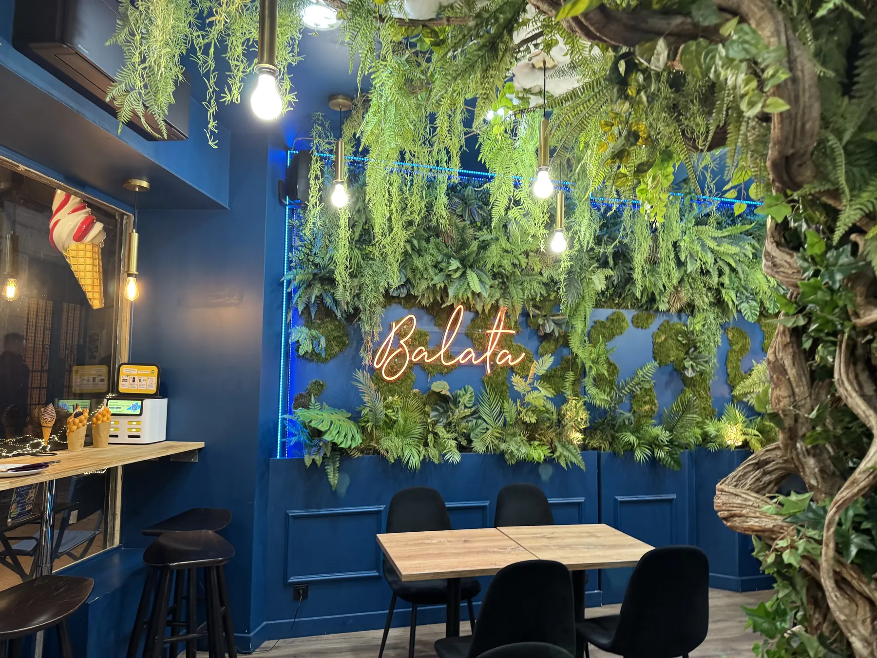 balata ice cream parlor, neon sign behind ferns